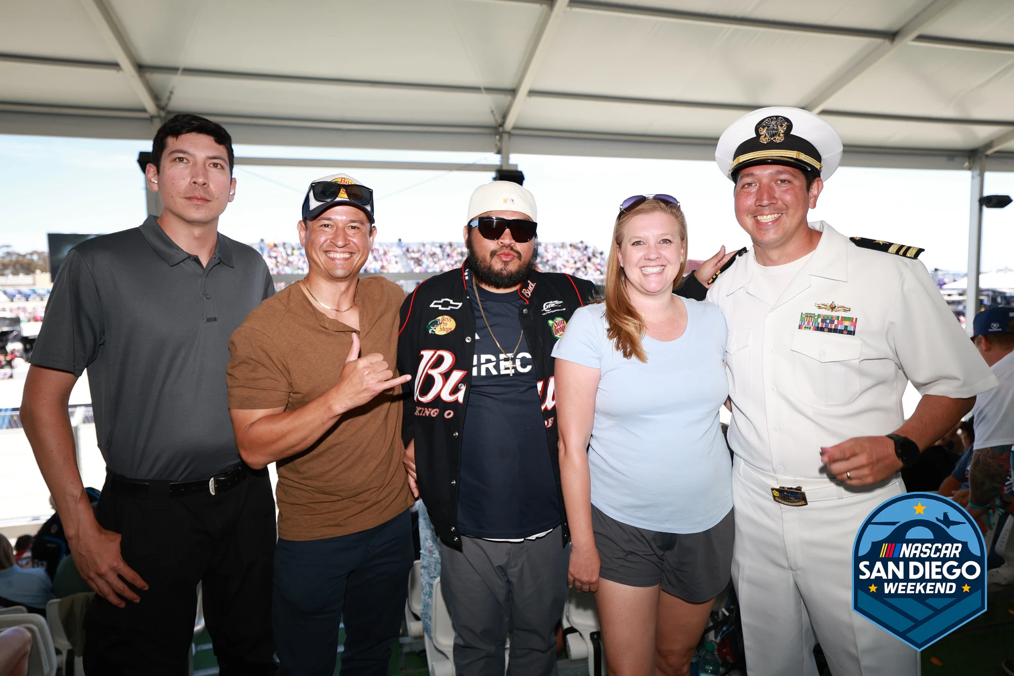 Six guests in the hospitality tent, one of them in Navy whites, at NASCAR San Diego